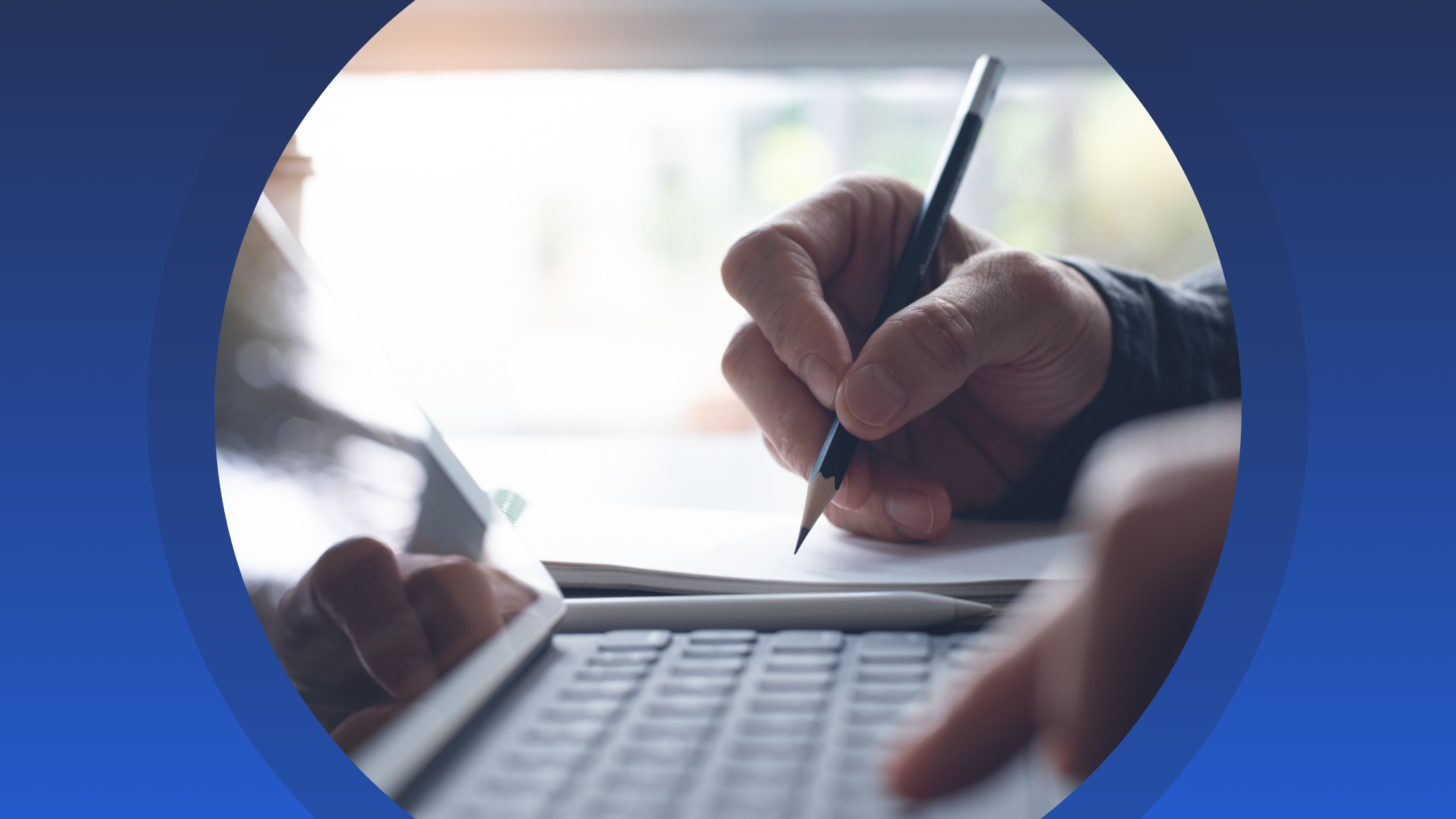 Person holding a pencil making notes in a notepad and using a laptop